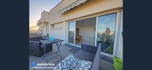 a balcony with a table and chairs on a building at Exceptional, 12 minutes RER C from Paris in Juvisy-sur-Orge +6 photos