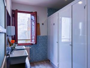 a bathroom with a shower and a sink and a window at Albergue Mayor in Sarria
