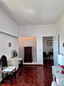 a living room with white walls and a wooden floor at Caparica for Rent in Costa da Caparica +153 photos