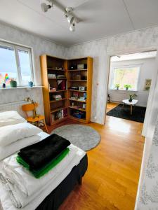a bedroom with a bed and a book shelf at Gästrum Vasaloppets vintervecka in Mora