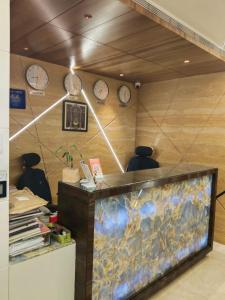 an office with a fish tank and clocks on the wall at SRS Suites in Bangalore