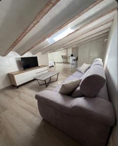 a living room with a couch and a table at Apartamentos San Gabriel in Alcalá de Henares