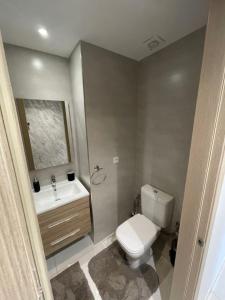 a bathroom with a white toilet and a sink at Moroccan Inspired 2BR Bright, Central & New in Oulad Akkou