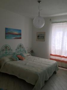 a bedroom with a bed and a pendant light at Apartment in a villa with a private pool in Cannigione +14 photos