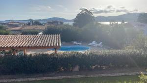 a backyard with a pool and two chairs and a blue raft at Apartment in a villa with a private pool in Cannigione