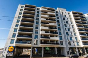 a tall apartment building on a city street at Elite Luxury Crib in Cluj-Napoca