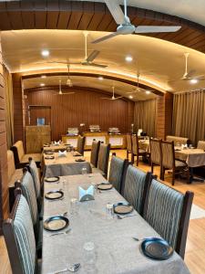 a large dining room with tables and chairs at Hotel Wardhman in Jabalpur