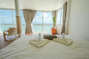 a bedroom with a large bed with two pillows on it at Beach Studio Level - WaveSide Ocean Bliss in Ko Phangan +48 photos