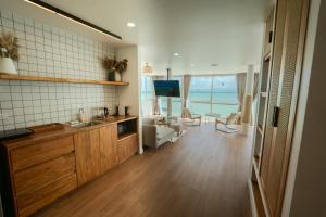 a room with a kitchen with a view of the ocean at Beach Studio Level - WaveSide Ocean Bliss in Ko Phangan