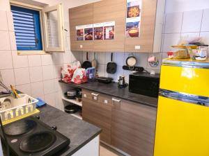 a kitchen with a yellow refrigerator and a counter at Hostel Budva in Budva