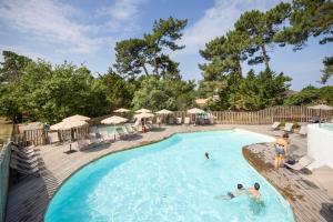 a group of people in a swimming pool at a resort at Huttopia Arcachon in Arcachon