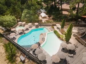 an overhead view of a swimming pool with umbrellas at Huttopia Arcachon in Arcachon