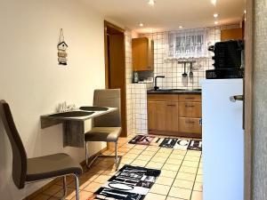 a kitchen with a counter and a refrigerator at Apartments Unterer Kochbuck in Crailsheim +3 photos