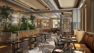 a restaurant with long tables and chairs and plants at The Bank by MYR Hotels in Valencia