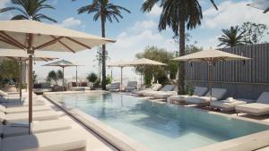 a swimming pool with lounge chairs and umbrellas at The Bank by MYR Hotels in Valencia