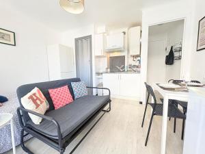 a living room with a couch and a table at Studio à Canet Plage 200m Mer Balcon in Canet-en-Roussillon