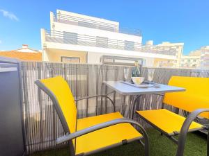 two yellow chairs and a table on a balcony at Studio à Canet Plage 200m Mer Balcon in Canet-en-Roussillon