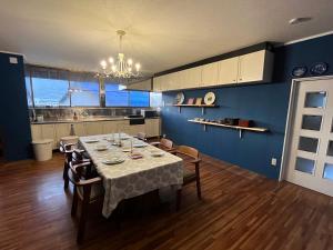 a dining room with a table with chairs and a kitchen at Riad Camellia in Mitoyo +44 photos