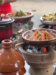 a pot of food is cooking on a stove at Kasbah Elmehdaoui in Skoura