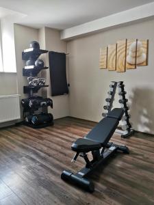 a room with a gym with a bench and equipment at Mercure Ostrava Center in Ostrava