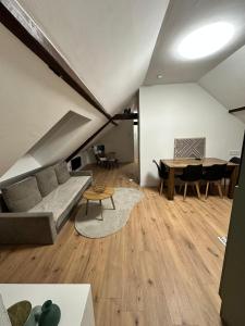 a living room with a couch and a table at Haus Lilium-Gemütliche Dachgeschoss Wohnung in Freudenstadt