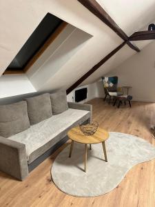 a living room with a couch and a table at Haus Lilium-Gemütliche Dachgeschoss Wohnung in Freudenstadt