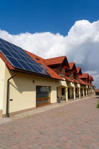 a building with solar panels on its roof at Private Vendégház in Villány
