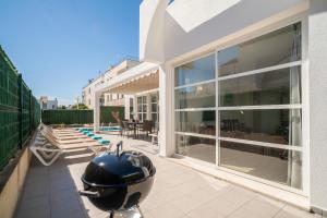 a large white house with a helmet on a patio at Villa Savina by BeBreeze in Can Picafort