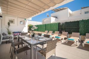 an outdoor patio with a table and chairs at Villa Savina by BeBreeze in Can Picafort