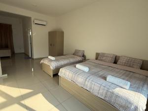 a bedroom with two beds and a couch at Sunshine Residence in Ayer Itam +19 photos