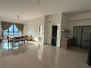a dining room and living room with a table and chairs at Sunshine Residence in Ayer Itam
