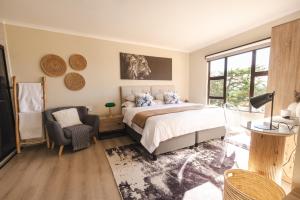 a bedroom with a large bed and a window at Rorkes Drift Lodge in Rorkeʼs Drift +186 photos