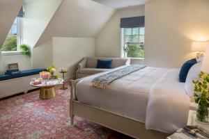 a bedroom with a large bed and a couch at Bohemia Manor Farm in Chesapeake City