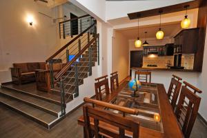 a kitchen and dining room with a table and a staircase at Villa Sanchana in Galle