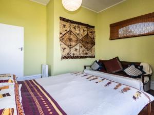 a bedroom with two beds and a rug on the wall at Oroua Cottage - Rangataua Bach in Ohakune