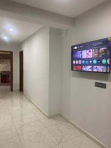 a room with a large screen on a wall at Moroccan Inspired 2BR Bright, Central & New in Oulad Akkou