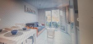 a drawing of a kitchen with a table and a couch at Ma maison près du golf in Talmont