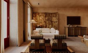 a living room with a white couch and a tv at chic&basic Tokyo Hoose in Porto