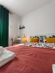 a bedroom with a large red bed with a green curtain at Apartman Turkalj in Rakovica