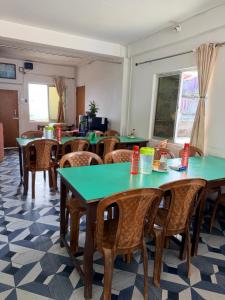 a dining room with tables and chairs in a room at Kalimpong Heritage Homestay in Kalimpong