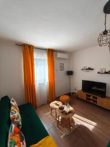 a living room with a couch and a table at Apartman Turkalj in Rakovica