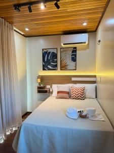 a bedroom with a large bed with two bowls on it at Econteiner Hotel Juruti in Juruti +6 photos