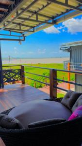 a couch on a deck with a view of the beach at Econteiner Hotel Juruti in Juruti