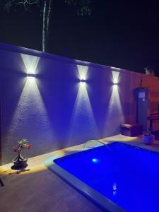 a blue swimming pool with lights on a wall at Econteiner Hotel Juruti in Juruti