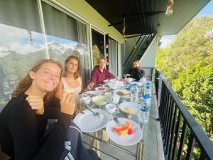 a group of people sitting at a table with food at Lavee Villa Ella in Ella