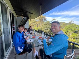 a group of people sitting at a table eating food at Lavee Villa Ella in Ella +26 photos