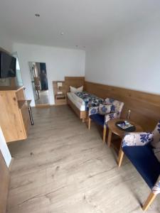 a living room with two beds and a table at Hotel Falkenseer Hof in Falkensee