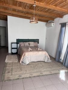 a bedroom with a large bed in a white room at La martinez in San Antonio de Areco