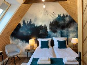 a bedroom with a large painting on the wall at Bystre DOMKI in Nowe Bystre