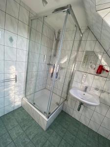 a bathroom with a shower and a sink at Hotel Falkenseer Hof in Falkensee